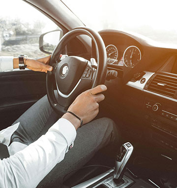 Man driving a new automobile