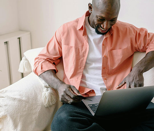 A man using a credit or debit card on his laptop computer