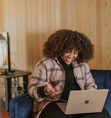 Lady using her laptop computer in her home